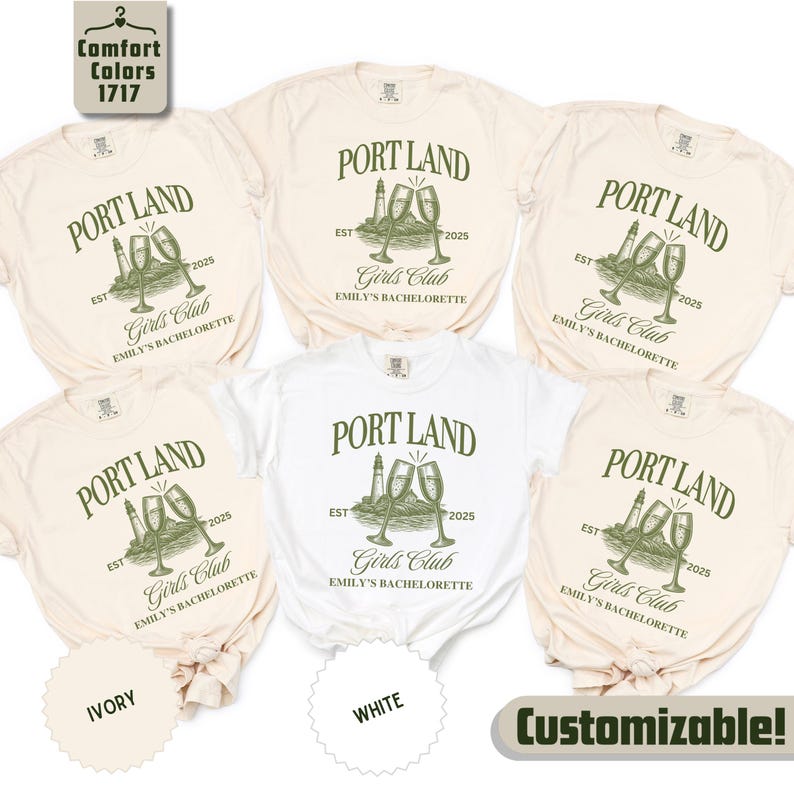 May include: Five short-sleeved crew neck t-shirts in ivory and white. Each shirt features a dark green graphic with the text PORT LAND, EST 2025, Girls Club, and EMILY'S BACHELORETTE, alongside an illustration of a lighthouse and two champagne flutes.