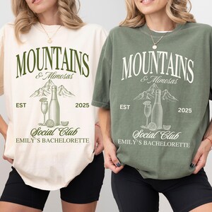 Mountains and Mimosas Bachelorette Shirt, Custom Bride Trip Tee, Cabin Bach Party Shirt, Hiking Bridal Group Tee, Mimosa Team Bach T-Shirt