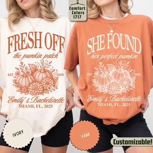 May include: Two t-shirts, one ivory and one yam-colored, with fall-themed graphics. The ivory shirt reads "FRESH OFF the pumpkin patch" and the yam shirt says "SHE FOUND her perfect pumpkin." Both shirts feature pumpkin and floral designs, with "Emily's Bachelorette, Miami, FL, 2025."