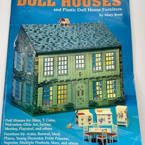 May include: A book titled "Tomart's Price Guide to Tin Litho DOLL HOUSES and Plastic Doll House Furniture" by Mary Brett. The cover features a detailed illustration of a two-story dollhouse with a blue roof and green walls. Miniature dollhouse furniture is also shown.