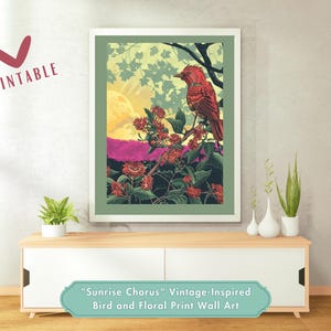 May include: A framed vintage-inspired print featuring a red bird perched on a flowering branch. The artwork includes a sunrise, with the word "Printable" in the upper left corner. The print is displayed on a white cabinet.