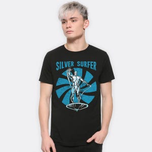 May include: Black t-shirt with a graphic of the Silver Surfer character and the text "SILVER SURFER" in blue. The design includes a blue radial pattern behind the character. The Silver Surfer is depicted in silver, standing on a surfboard.