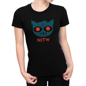 May include: Black t-shirt featuring a blue cat face graphic and the text "NITW" in orange.