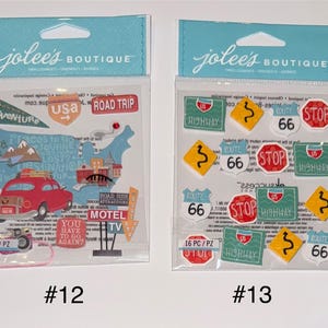 May include: Two packages of stickers with a road trip theme. The first package has 9 stickers and features a red car, a motel sign, and a map of the United States. The second package has 16 stickers and features various road signs, including "Route 66", "Highway", and "Stop".
