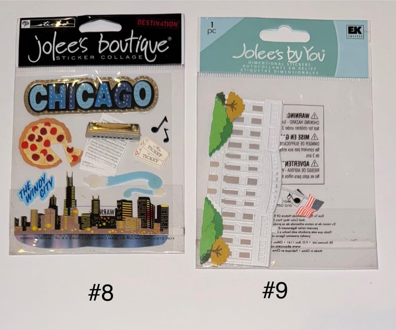 May include: Two packs of dimensional stickers, one with a Chicago theme and the other with a White House theme. The Chicago pack includes a pizza slice, a harmonica, a skyline, and the words "The Windy City". The White House pack includes a white building with a green lawn and a small American flag.