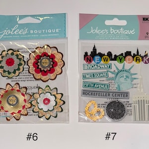 May include: Two packages of New York City themed stickers. The first package has four stickers with a floral design and the text "NYC". The second package has nine stickers with images of the Statue of Liberty, a manhole cover, and buildings. The text "New York" is on the package.