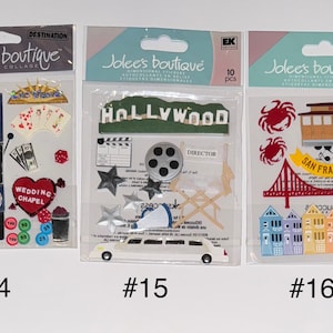 May include: Three packs of dimensional stickers featuring various themes. The first pack has a Las Vegas theme with images of a slot machine, wedding chapel, dice, and playing cards. The second pack has a Hollywood theme with images of a film reel, director's chair, and a limousine. The third pack has a San Francisco theme with images of a cable car, the Golden Gate Bridge, and houses.