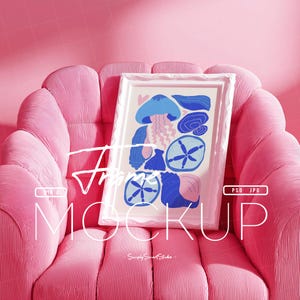 May include: A framed art print featuring a whimsical design of blue and pink sea creatures, including jellyfish and starfish. The artwork is displayed on a pink, ribbed armchair, creating a vibrant and stylish presentation. The frame is white.