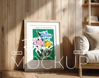 Pode incluir: Uma impressão artística emoldurada com uma ilustração floral de lírios azuis, rosa e amarelos sobre um fundo de grade verde. O texto "A GARDEN OF PURE EMOTION" é visível.