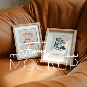 May include: Two framed art prints with coffee-themed illustrations. One features a red and white coffee maker, the other a green coffee bag and a glass. The frames are light wood, set against a brown leather background. Text on the frames reads "Frame Mockup".