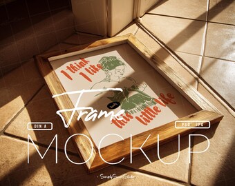 May include: A wooden picture frame mockup with a print featuring a woman's illustration and the text "I think I like this little life." The frame is rectangular and rests on a tiled surface, with the text "Frame Mockup" overlaid.