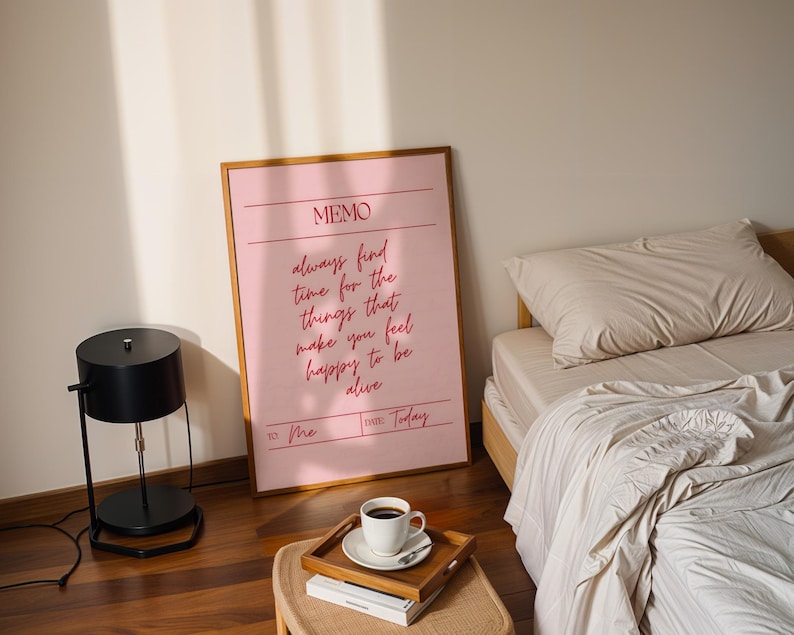 Uplifting pink wall print reminding viewers to prioritize happiness.