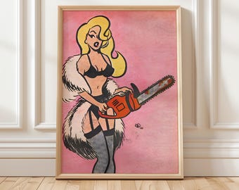 May include: Framed pop art print featuring a blonde woman in lingerie holding an orange chainsaw against a pink background. The artwork has a comic book style with bold outlines and a vintage aesthetic. The print is in a wooden frame.