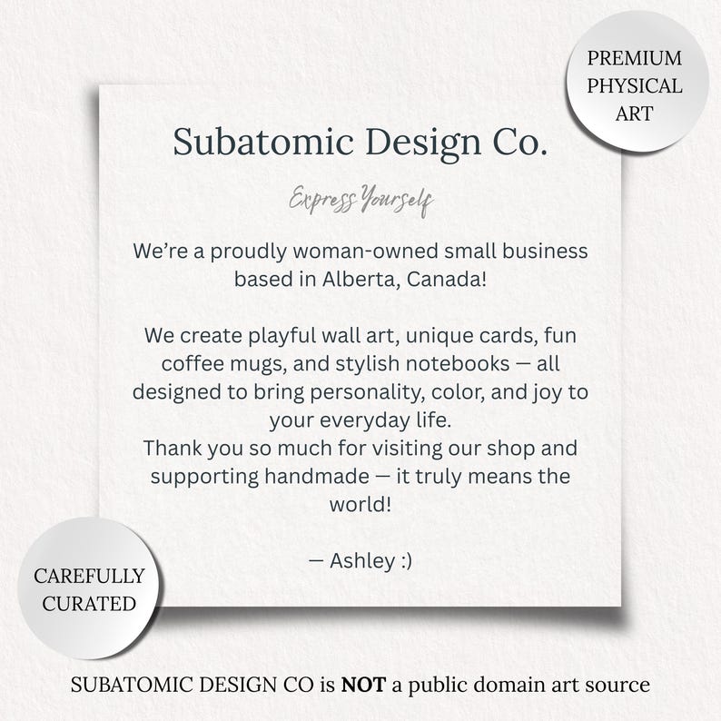 May include: A white card with the text "Subatomic Design Co. Express Yourself" and a message about creating playful art, cards, mugs, and notebooks. The card also includes the phrases "Premium Physical Art" and "Carefully Curated."