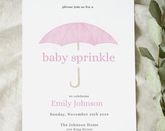 May include: A baby sprinkle invitation with a pink umbrella illustration. The text reads "baby sprinkle" and "Emily Johnson" with the date and address. The invitation is on a white background.