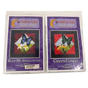 May include: Two packaged quilting patterns. One features a blue butterfly, white flowers, and the text "Blue Mt. Swallowtail." The other shows a green butterfly and yellow flowers with the text "Green Congo." Both are from the "IN FLIGHT" series.