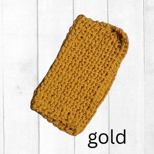May include: A rectangular, gold-colored, crocheted item. The item is made with a thick yarn and has a textured appearance. The word "gold" is written in black script at the bottom of the image.