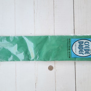 May include: A package of green crepe paper, 100 sq ft, flame resistant, by Dennison.