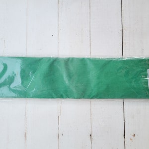 May include: A roll of green tissue paper wrapped in clear plastic.