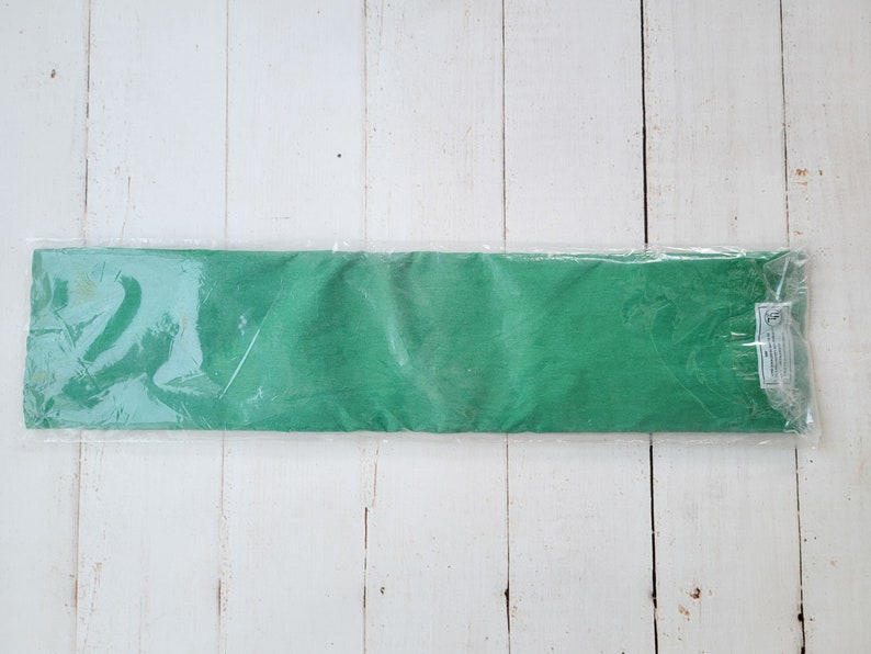 May include: A roll of green tissue paper wrapped in clear plastic.