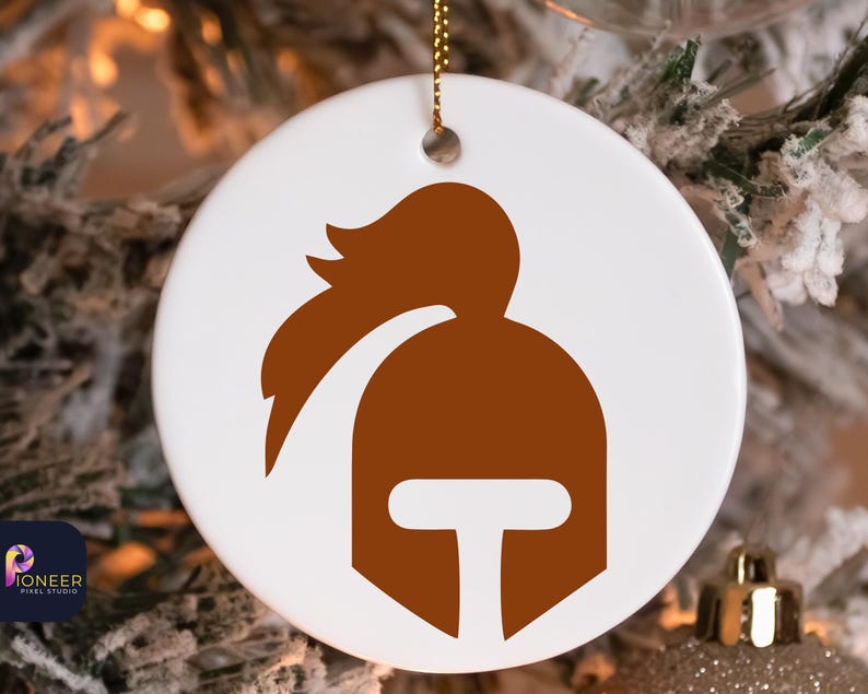 May include: A white ceramic ornament with a brown silhouette of a knight's helmet with a plume on top.