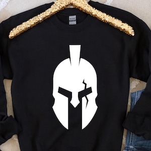 May include: Black sweatshirt with a white graphic of a Spartan helmet.