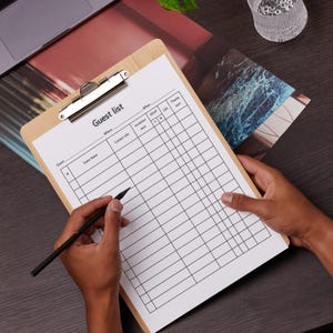 May include: A clipboard with a guest list form. The form has columns for event, guest name, contact info, invitation sent, RSVP, gift, and thanks sent.