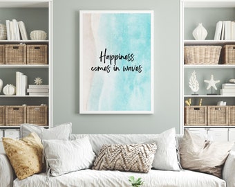 May include: A white framed print with a blue and pink watercolor background. The text "Happiness comes in waves" is written in black cursive.