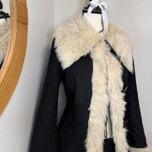 This full-length Black Suede Afghan Coat brings together cozy warmth and bold retro flair. The cream shaggy trim adds texture and contrast, while the suede exterior keeps the coat durable and soft. Perfect for cold-weather styling, travel adventures, and vintage-inspired wardrobes seeking a luxurious handmade winter coat.