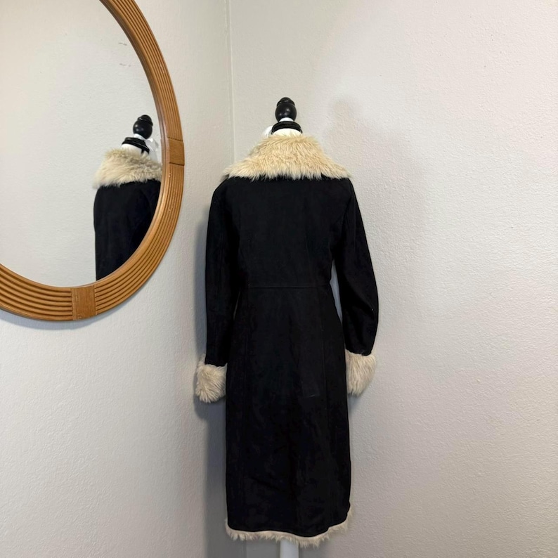Elevate your winter wardrobe with this gorgeous Black Suede Penny Lane Coat. Designed with rich suede leather and dramatic cream shaggy trim, it captures the essence of 70s bohemian glamour. Ideal for festivals, travel, cold-weather outings, and vintage enthusiasts who want a striking, comfortable, standout coat.