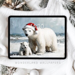 May include: A digital illustration of two polar bears on a snowy beach. The larger bear is wearing a red Santa hat and the smaller bear is standing next to it. The image is displayed on a tablet screen with the text "Wednesday 21 December 14:30" and "WONDERLAND WALLPAPERS" on the screen.