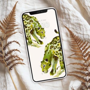 Pode incluir: Um smartphone branco com uma ilustração de aquarela verde e amarela de dois leopardos. A tela do telefone mostra a hora "14:30" e a data "Segunda-feira, 4 de julho".