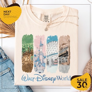 a white t-shirt with a graphic design depicting various Disney landmarks, including the Walt Disney World resort, the Eiffel Tower, and the Hollywood sign. The t-shirt is displayed on a white background, and there are two yellow sale signs indicating a 30% discount on the item.