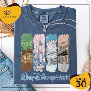 A t-shirt with a graphic design featuring illustrations of various Disney landmarks, including the Walt Disney World theme park, the Gold Tower, and the Eiffel Tower. The t-shirt is displayed on a white background, and there are yellow and black sale signs indicating a 30% discount.