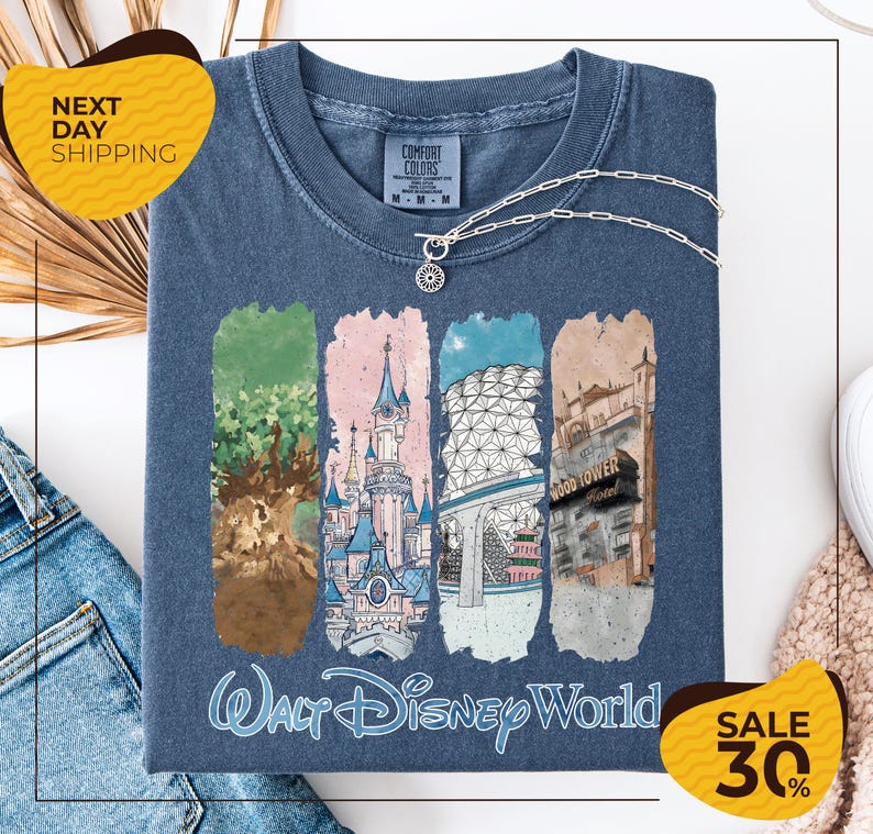 A t-shirt with a graphic design featuring illustrations of various Disney landmarks, including the Walt Disney World theme park, the Gold Tower, and the Eiffel Tower. The t-shirt is displayed on a white background, and there are yellow and black sale signs indicating a 30% discount.
