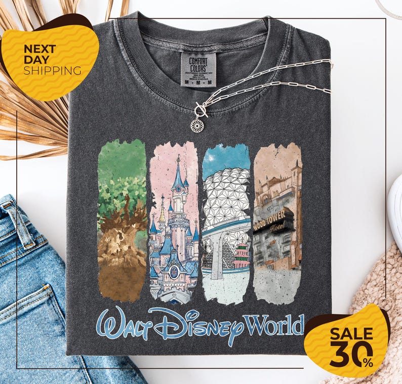 a gray t-shirt with a graphic design depicting various Disney World landmarks, including the Walt Disney World resort, the Wood Tower, and the Epcot Pavilion. The t-shirt is displayed on a white background, and there are two yellow sale signs indicating a 30% discount on the item.