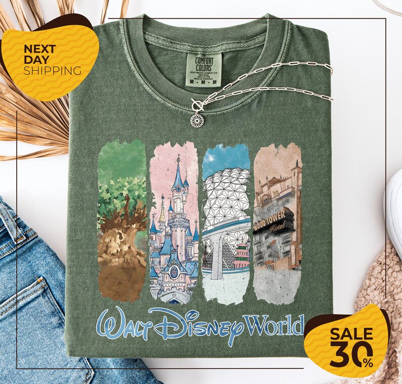 a green t-shirt with a graphic design of various Disney World landmarks, including the Walt Disney World resort, the Epcot International Space Needle, and the Hollywood Hills. The t-shirt is displayed on a white background, and there are yellow and black sale signs indicating a 30% discount on the item.