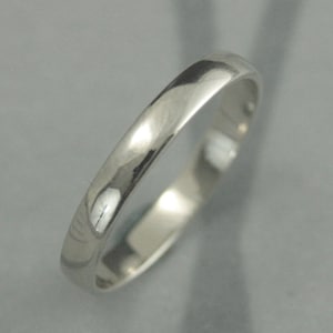 May include: A simple, polished silver wedding band.