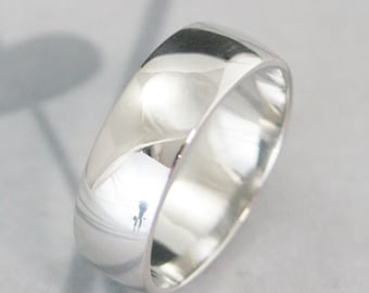 May include: A simple, polished silver wedding band.