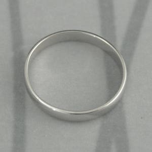 May include: A simple silver wedding band.