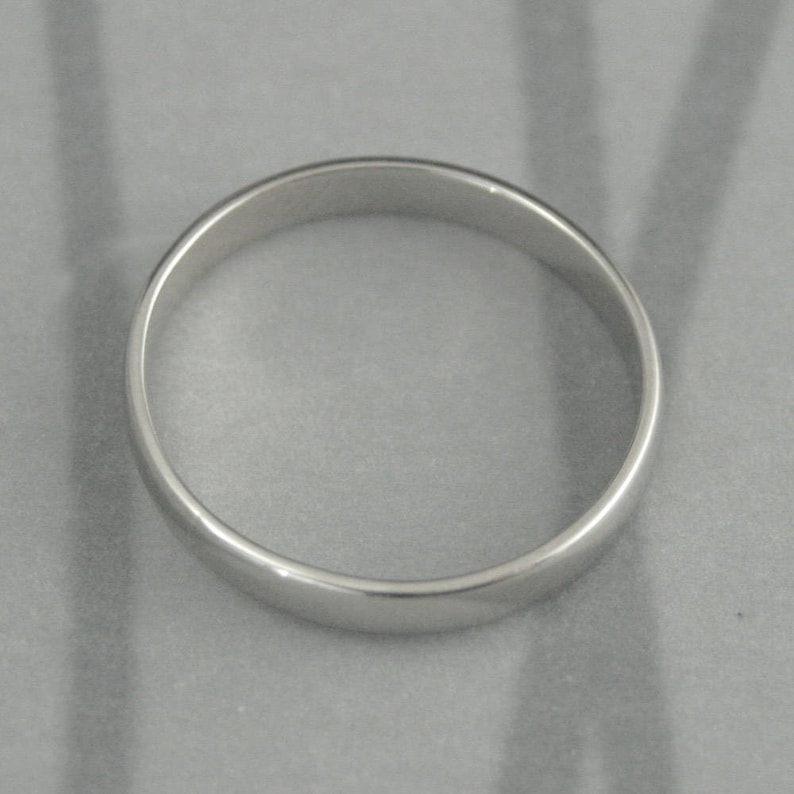 May include: A simple silver wedding band.