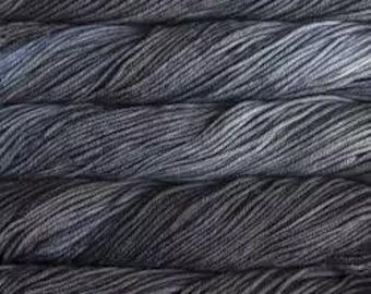 May include: A skein of dark blue yarn with a subtle gradient of lighter blue and gray shades.
