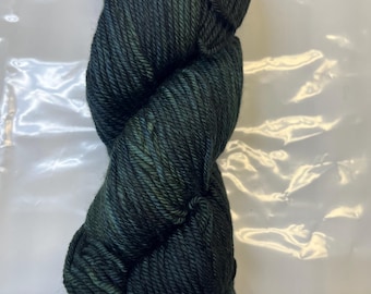 May include: A skein of dark green yarn with a subtle color variation.