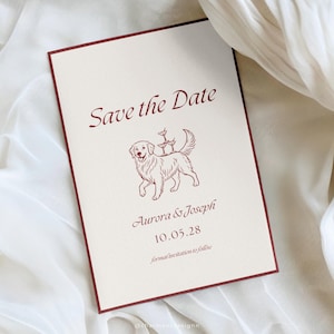 May include: A cream-coloured wedding invitation with a burgundy border. The text "Save the Date" is at the top, with the names "Aurora & Joseph" and the date "10.05.28" below. A line drawing of a dog carrying drinks is in the centre.