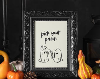 May include: Black framed art print with the text "pick your poison" and a cartoon illustration of two ghosts. One ghost pours champagne into a glass for the other. Halloween decor.