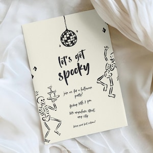 May include: Cream-colored Halloween party invitation with black text and illustrations. The invitation reads "Let's get spooky" and includes skeleton figures, a disco ball, and party details. The invitation is rectangular.