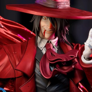 May include: A 3D printed model of a vampire with a red coat, black suit, and a wide-brimmed red hat. The model has a sinister smile and is holding a hand up in a gesture of greeting. The model is set against a dark background with a red fabric draped over it. The text "3Dmoonn October reward available on my patreon" is visible in the lower left corner of the image.