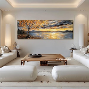 May include: A panoramic landscape painting depicting a lake with a golden sunset, a lone tree with orange leaves in the foreground, and a mountain range in the background.