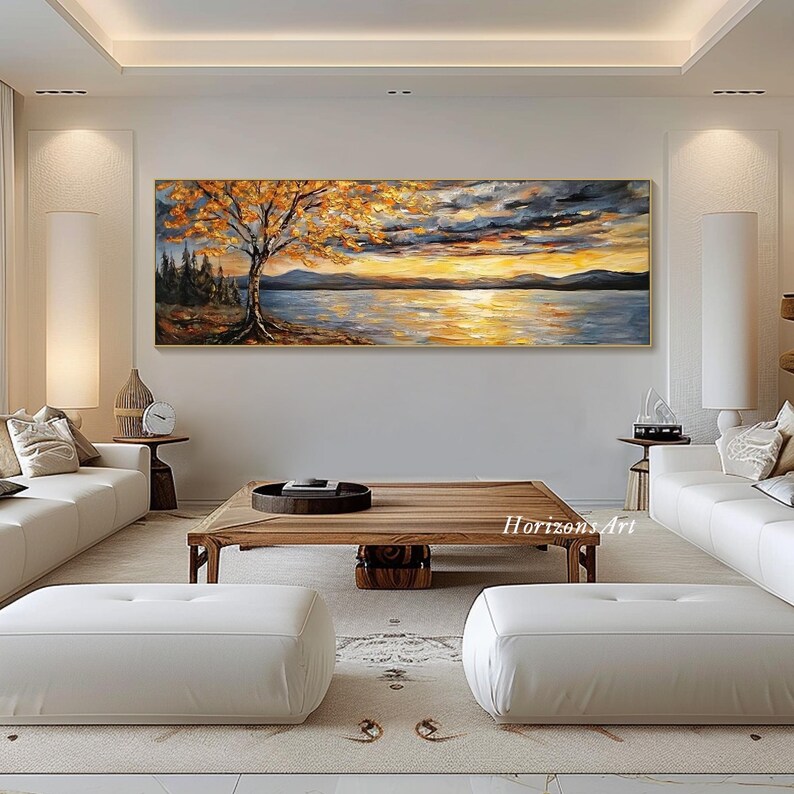 May include: A panoramic landscape painting depicting a lake with a golden sunset, a lone tree with orange leaves in the foreground, and a mountain range in the background.