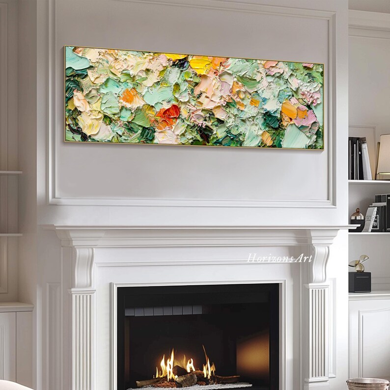 May include: Abstract painting with a textured, impasto style. The painting features a mix of green, yellow, orange, and pink colors. The painting is displayed above a fireplace in a white room.